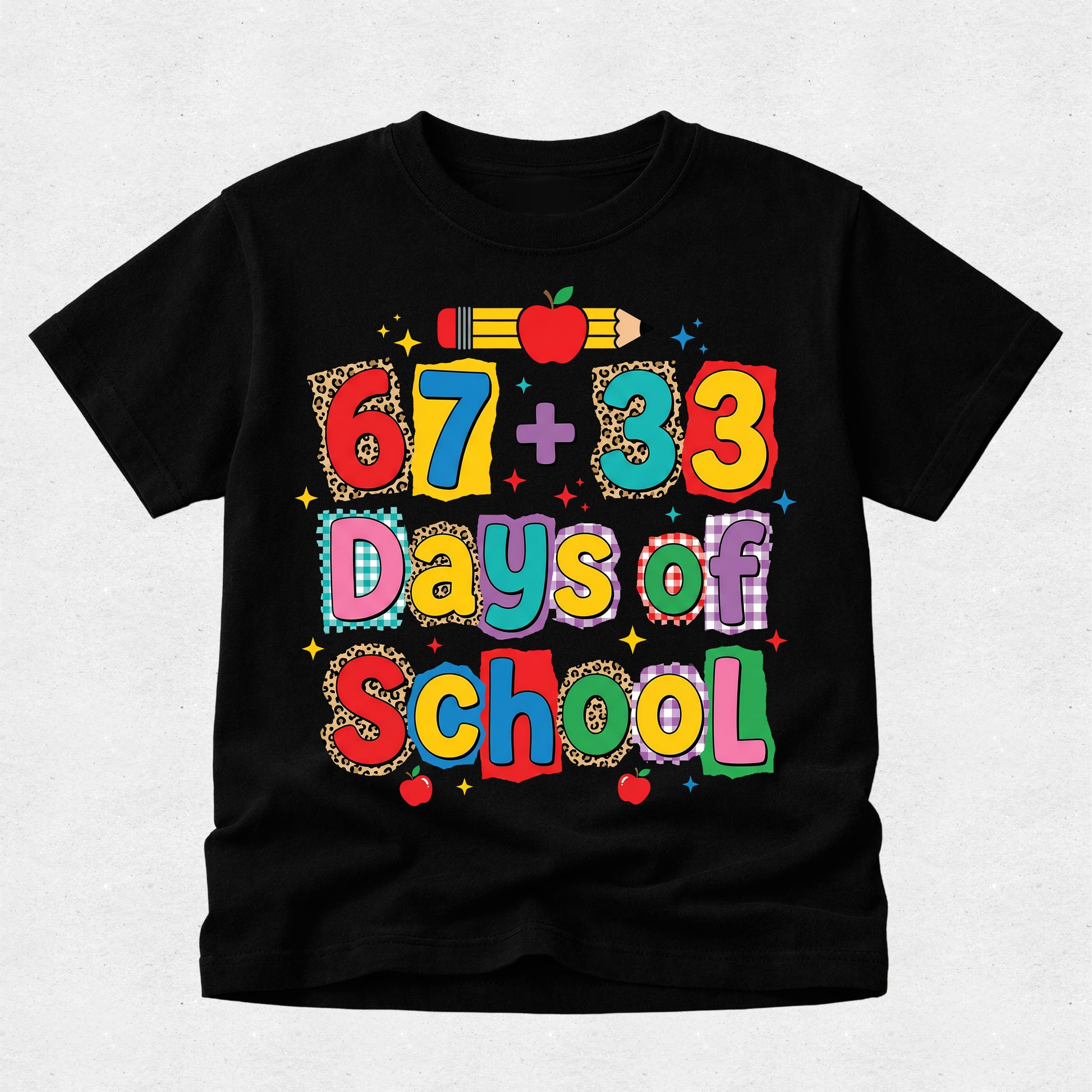 A black short-sleeve t-shirt with a colorful graphic reading '67 + 33 Days of School' in playful multicolor lettering, decorated with school-themed motifs like an apple, pencil, and stars, shown on a light gray textured background.