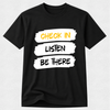 A black short-sleeve crewneck t-shirt with a graphic print on the front. The graphic consists of three white brushstroke blocks containing the text 'CHECK IN', 'LISTEN', and 'BE THERE' in yellow, black, and white lettering, respectively.