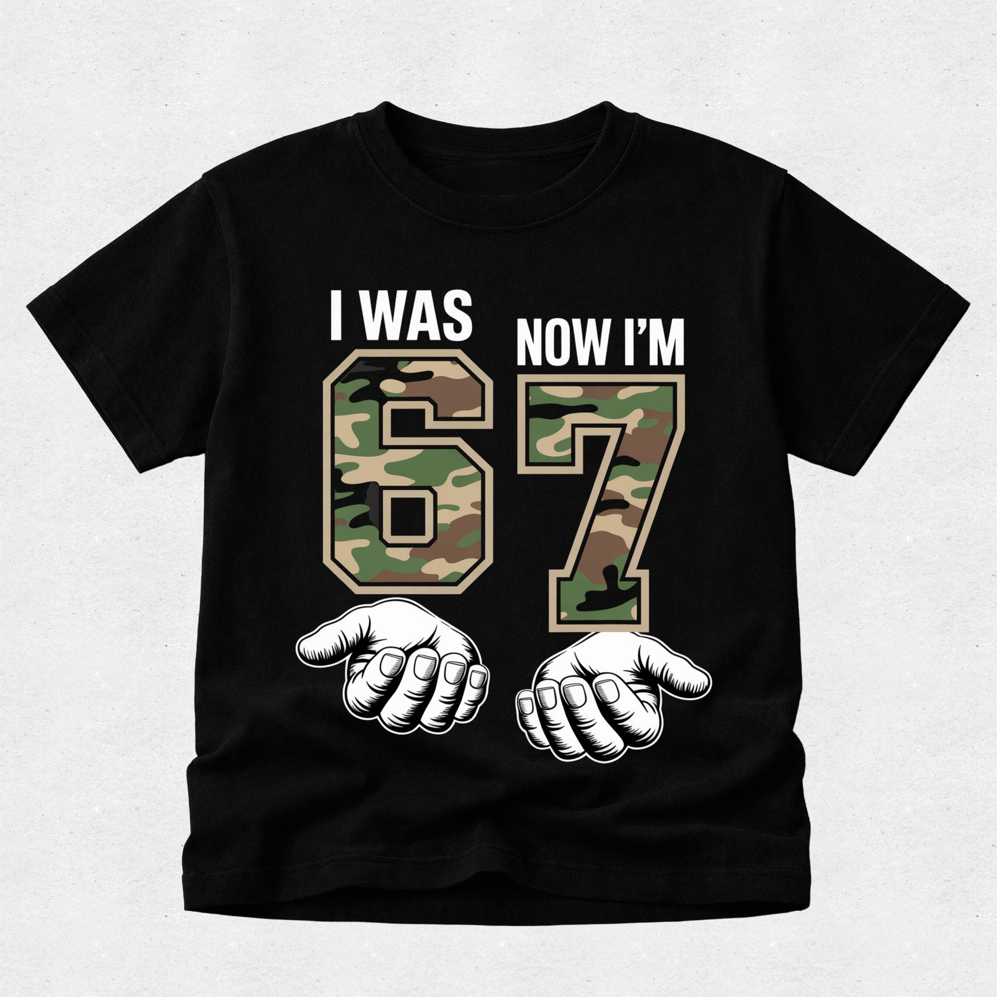 Black t-shirt with camouflage numbers '67' and text 'I was now I'm' on a light gray background