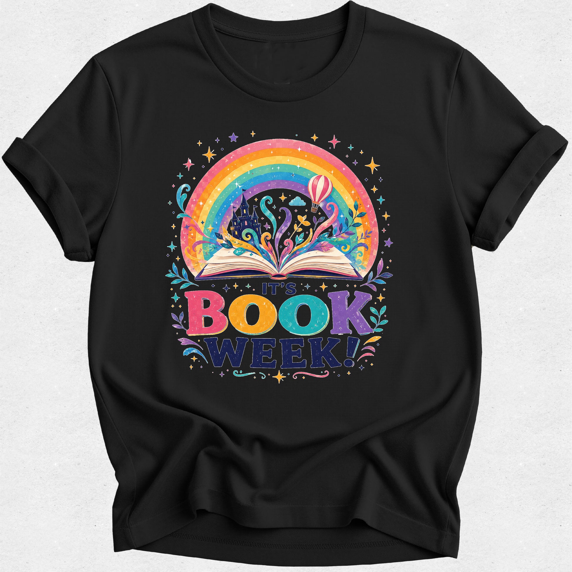 A black short-sleeve crewneck t-shirt featuring a colorful graphic of an open book with a rainbow and stars, and the text 'THE BOOK WEEK!' printed below it.