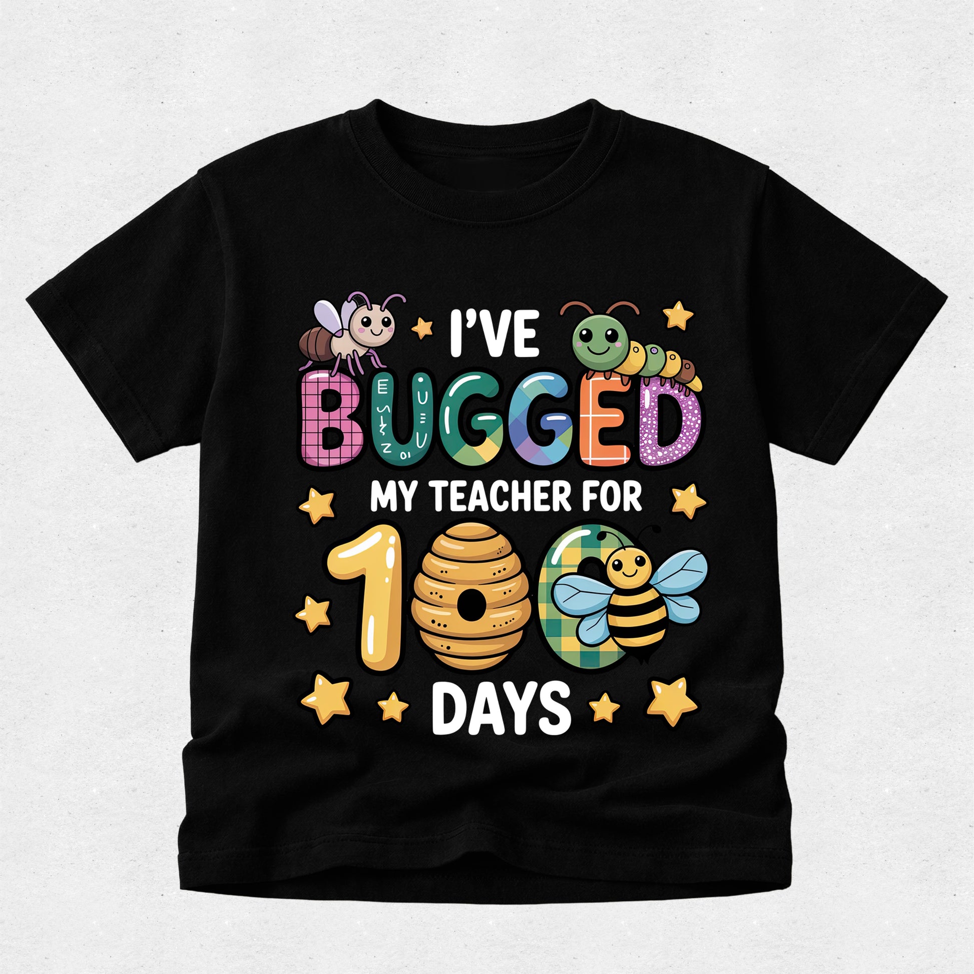 A black short-sleeve t-shirt with a colorful graphic design celebrating a teacher's 100th day, featuring cartoon bees, a beehive, stars, and the text 'I'VE BUGGED MY TEACHER FOR 100 DAYS'.