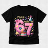 Black t-shirt with a colorful birthday design on a light gray background