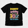 A black short-sleeve t-shirt with a colorful graphic on the front that reads 'DONUT lose your Sprinkles but it's the 100th Day of School' above three cartoon donuts, shown on a light gray background.