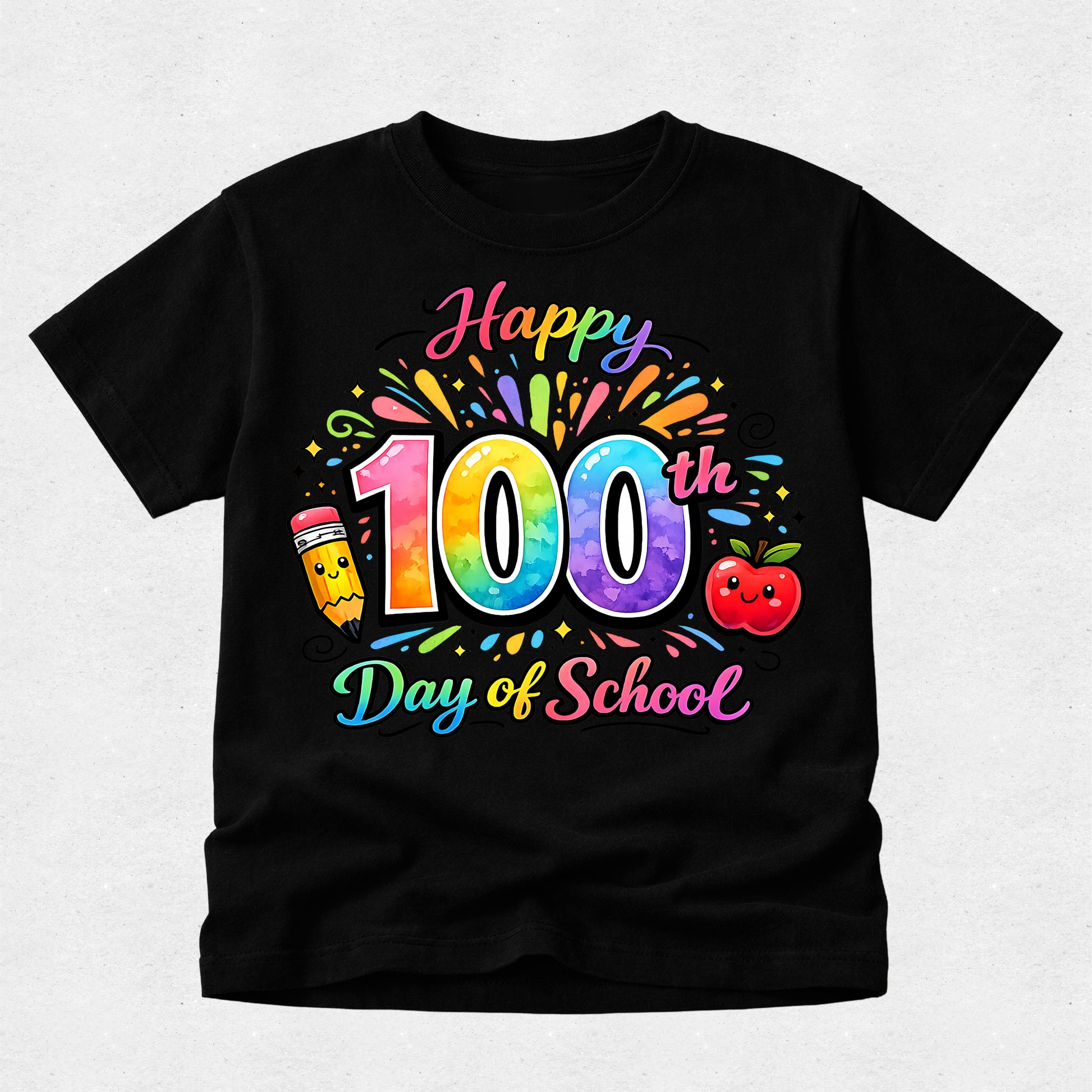 A black short-sleeve t-shirt with a colorful 'Happy 100th Day of School' graphic on the front, featuring a rainbow pencil, smiling apple, and confetti details, displayed on a light gray textured background.