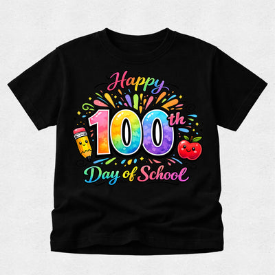 A black short-sleeve t-shirt with a colorful 'Happy 100th Day of School' graphic on the front, featuring a rainbow pencil, smiling apple, and confetti details, displayed on a light gray textured background.