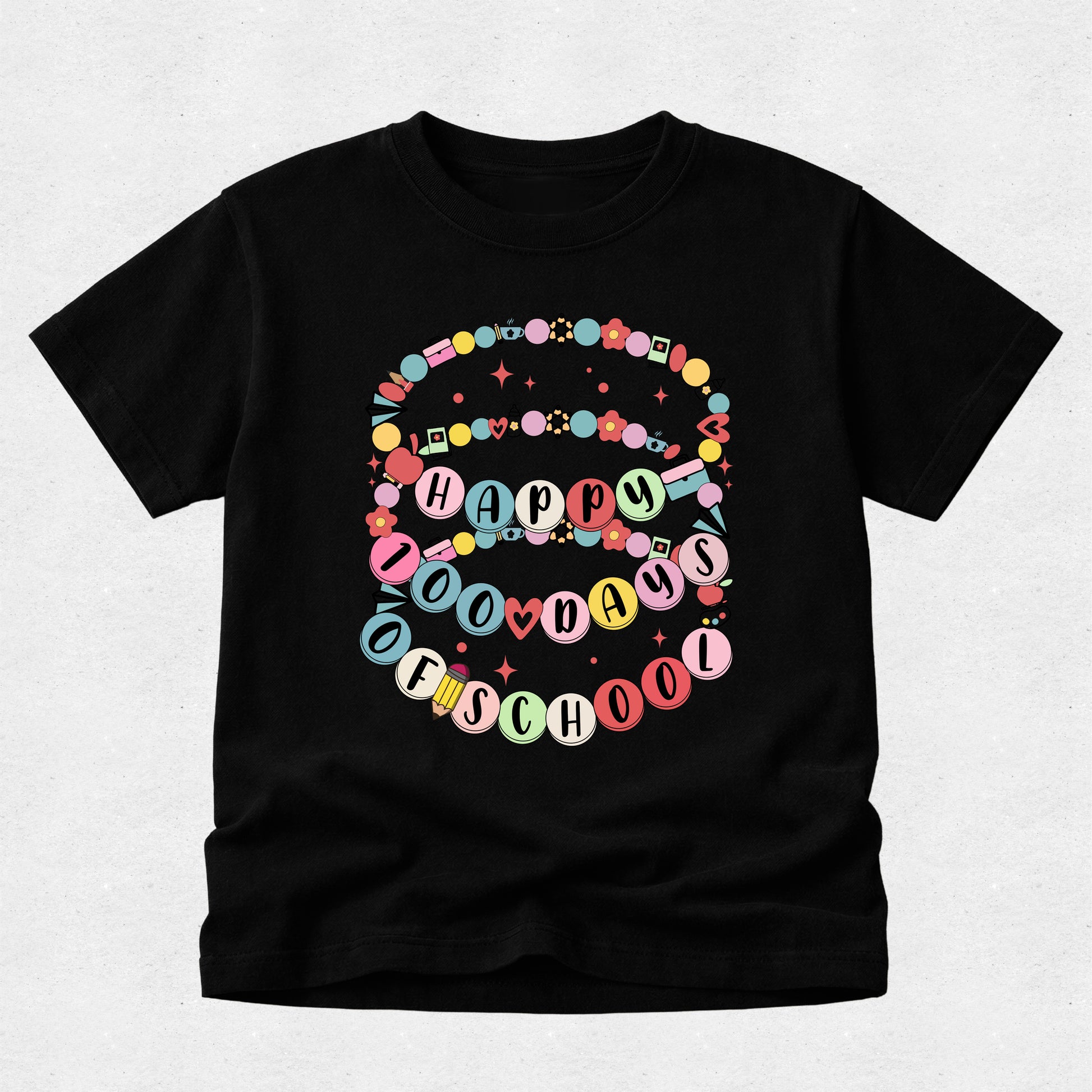 A black short-sleeve t-shirt with a colorful graphic on the front that reads 'HAPPY 100 DAYS OF SCHOOL' in pastel-colored letter circles and decorative ribbon details, shown against a light gray background.