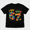 Black t-shirt with colorful birthday design on a light gray background