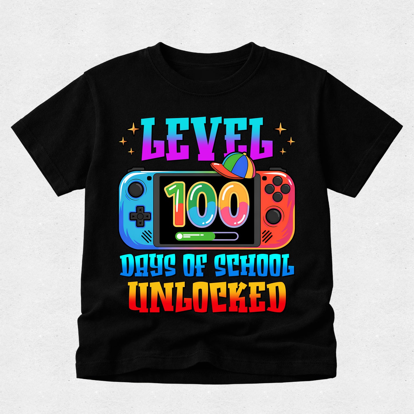 A black short-sleeve t-shirt with a colorful graphic on the front. The graphic features the text 'LEVEL 100 DAYS OF SCHOOL UNLOCKED' in a rainbow gradient font, with a Nintendo Switch console illustration in the center.
