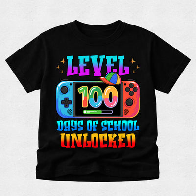 A black short-sleeve t-shirt with a colorful graphic on the front. The graphic features the text 'LEVEL 100 DAYS OF SCHOOL UNLOCKED' in a rainbow gradient font, with a Nintendo Switch console illustration in the center.