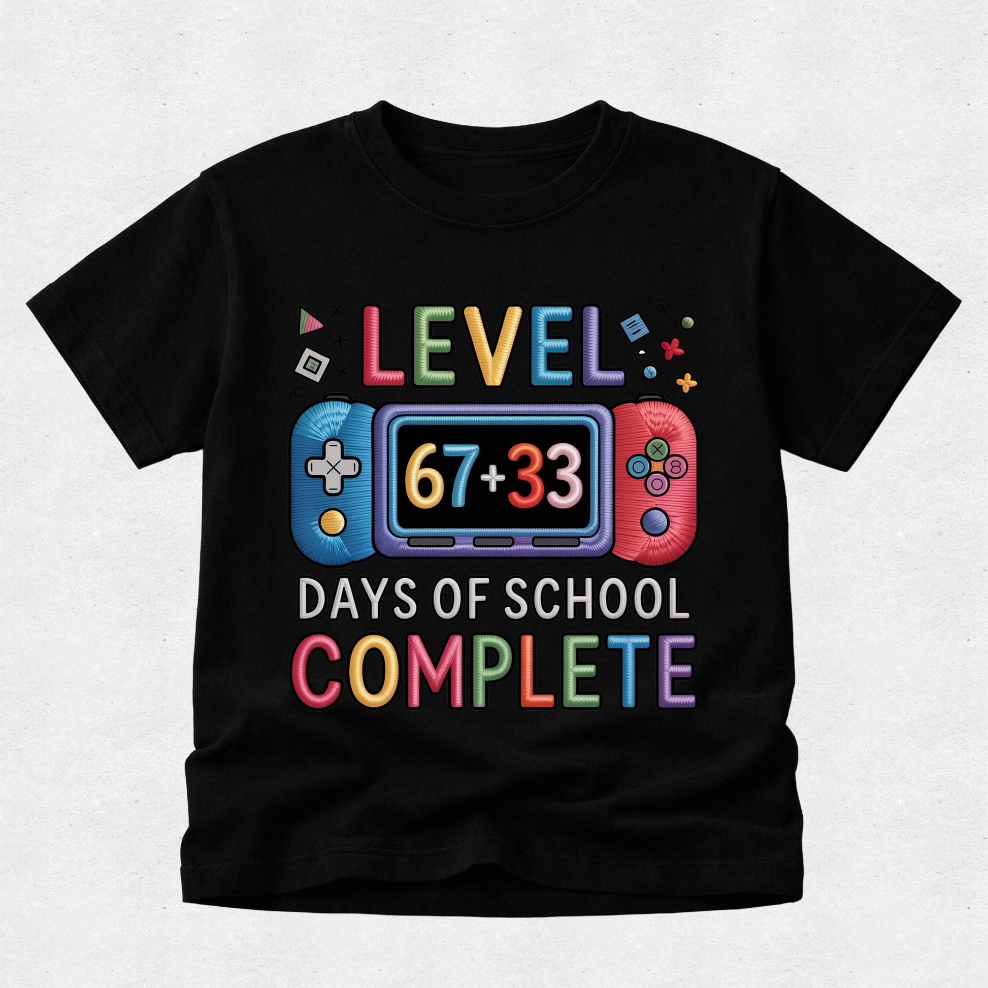 A black short-sleeve t-shirt with a colorful video game graphic that reads 'LEVEL 67+33 DAYS OF SCHOOL COMPLETE' on a light gray background.
