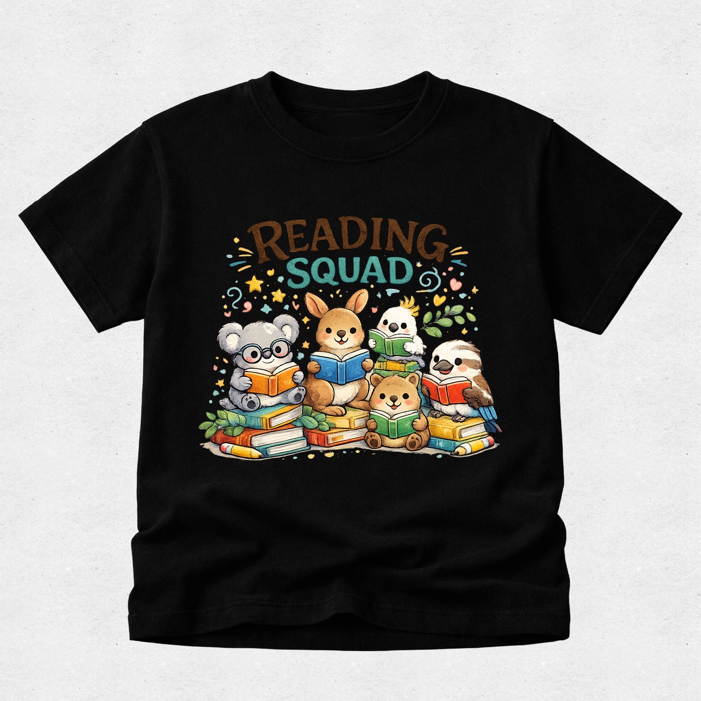 A black short-sleeve t-shirt with a colorful cartoon graphic of five cute animals reading books, with the text 'READING SQUAD' above them, displayed on a light gray background.
