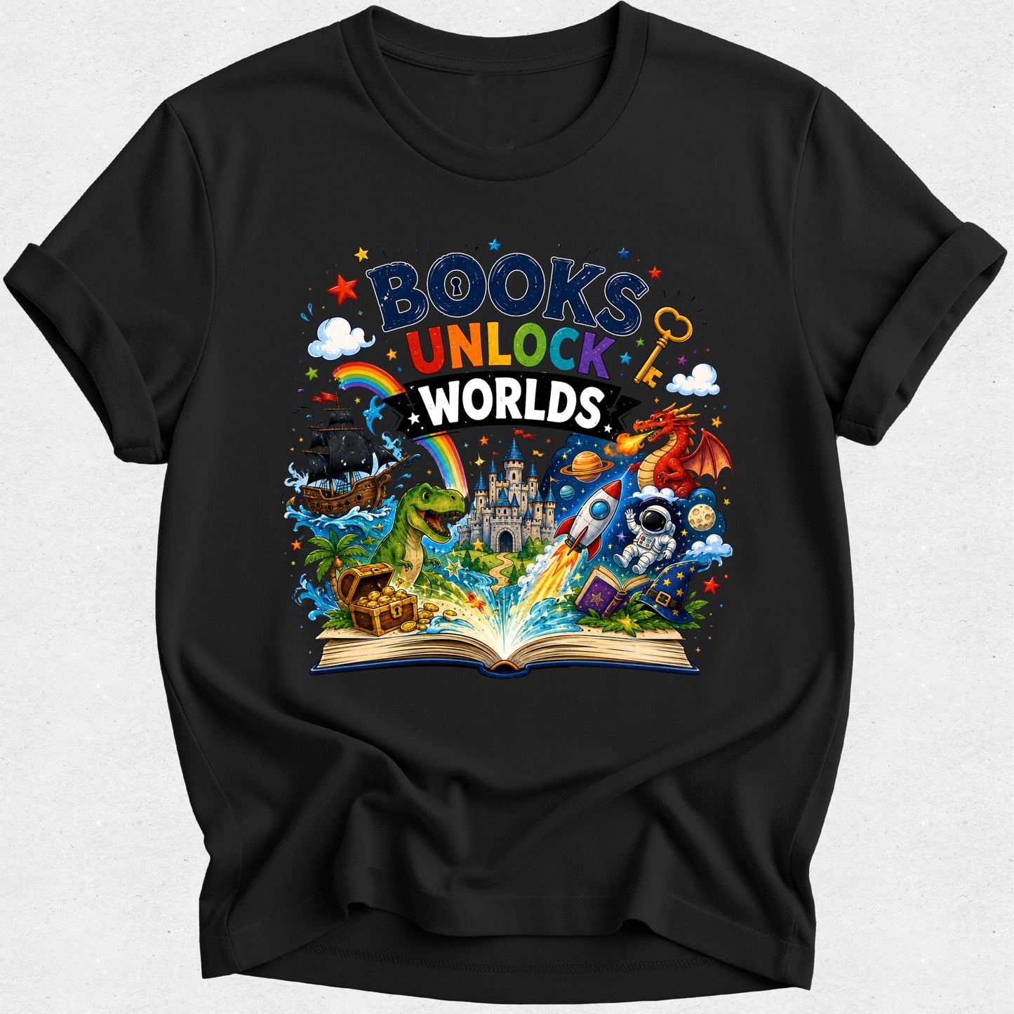 A black short-sleeve crewneck t-shirt with a colorful graphic print on the front that reads 'BOOKS UNLOCK WORLDS' above an open book with various fantasy and sci-fi illustrations including a dinosaur, castle, rocket, and astronaut.