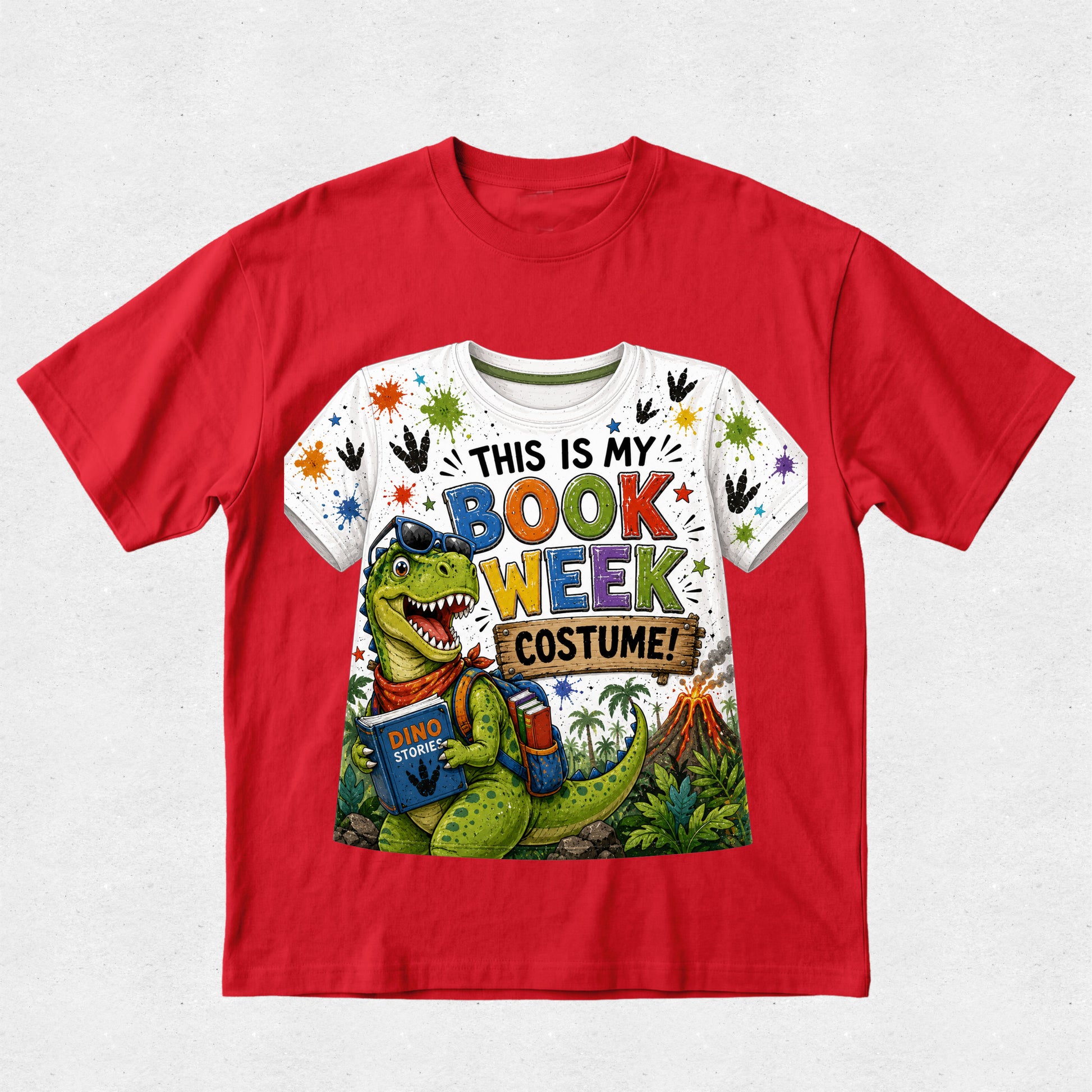 A red short-sleeve crewneck t-shirt featuring a colorful graphic print on the front. The graphic shows a green cartoon dinosaur wearing blue glasses and a red bandana, holding a book, with the text 'THIS IS MY BOOK WEEK COSTUME!' in multicolored letters.