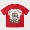 A red short-sleeve crewneck t-shirt featuring a colorful graphic print of a white t-shirt with a robot and the text 'THIS IS MY BOOK WEEK COSTUME!'.