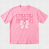 Pink t-shirt with decorative text and bow design on a light gray background
