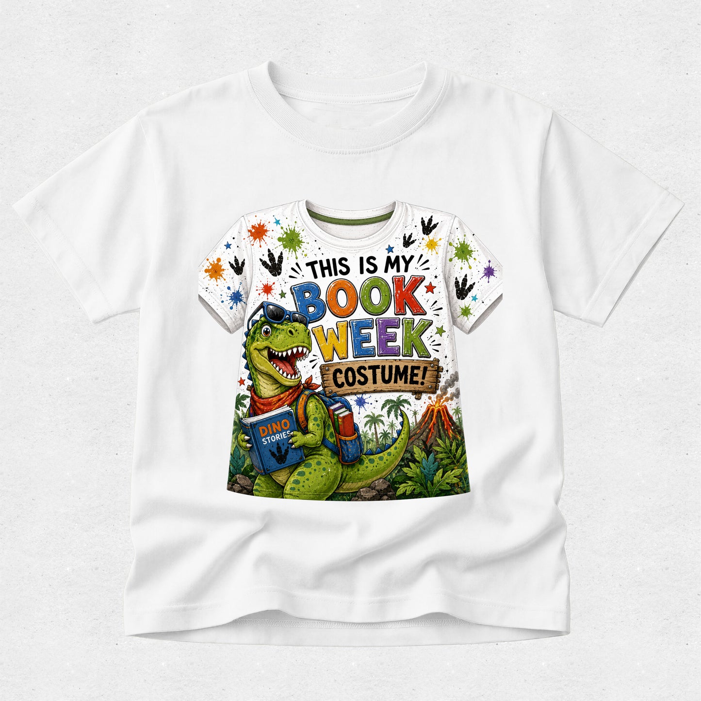A white short-sleeve crewneck t-shirt featuring a colorful graphic print of a green dinosaur wearing sunglasses and holding books, with the text 'THIS IS MY BOOK WEEK COSTUME!' in multicolored letters.