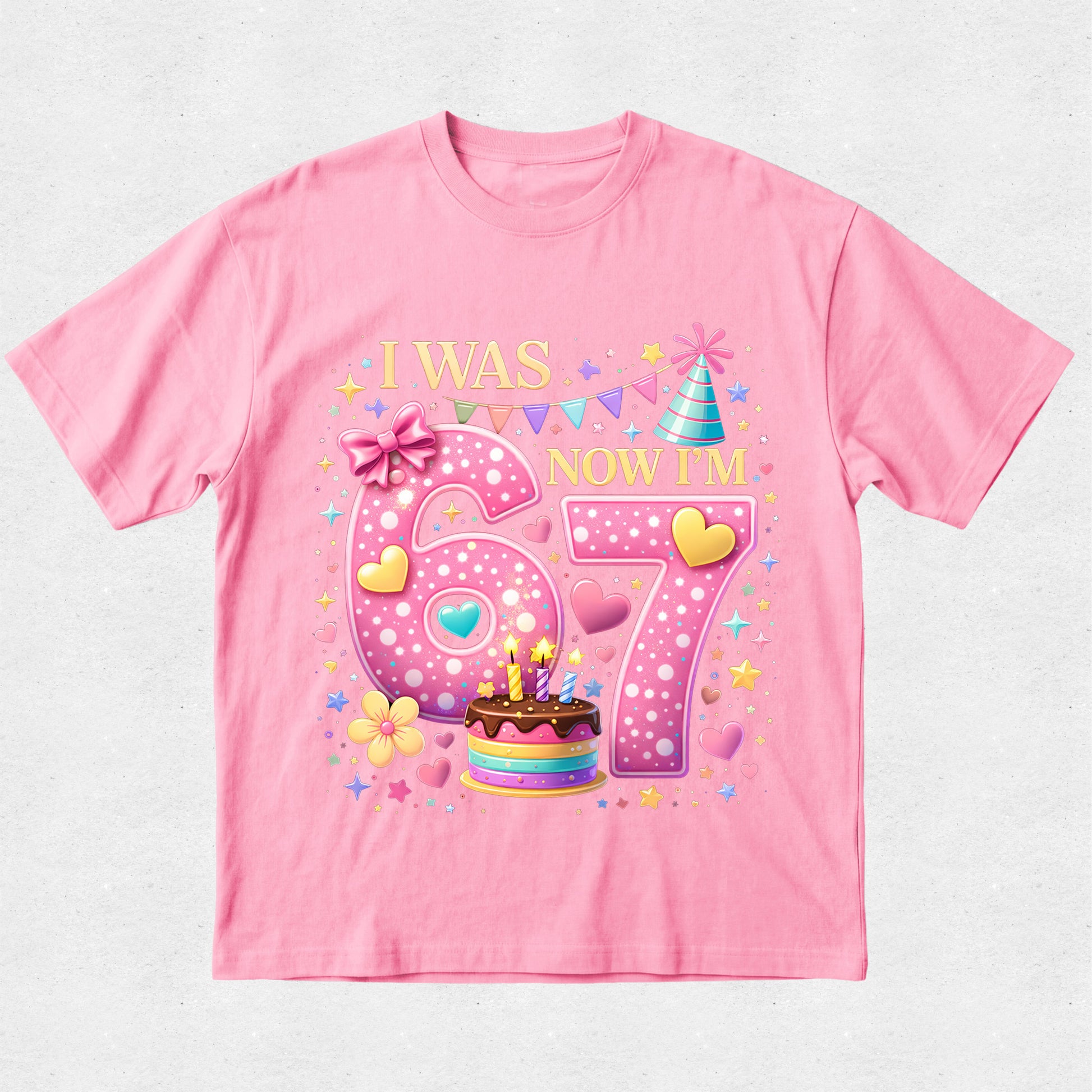 Pink t-shirt with birthday-themed design on a light gray background