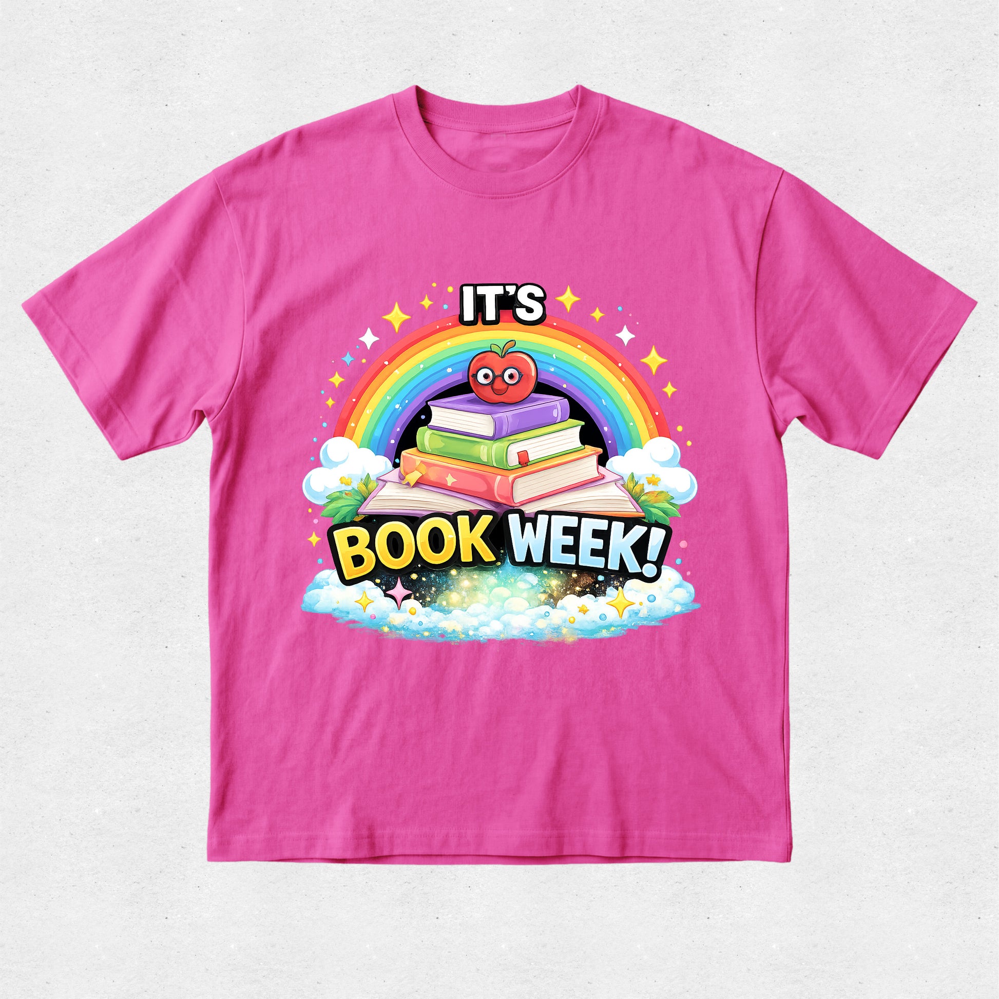 A bright pink short-sleeve t-shirt with a colorful cartoon graphic on the front that reads 'IT'S BOOK WEEK!' under a rainbow and stack of books.