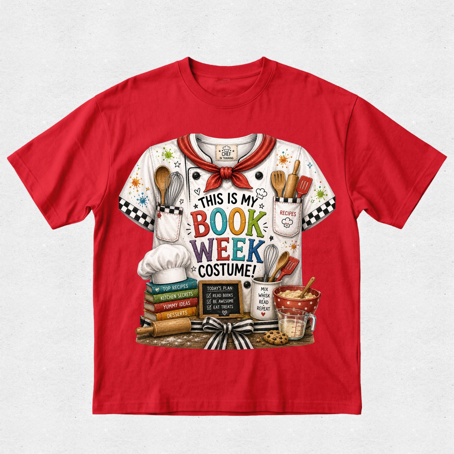 A red short-sleeve crewneck t-shirt featuring a colorful graphic print of a white chef jersey with 'THIS IS MY BOOK WEEK COSTUME!' text and baking-themed illustrations.