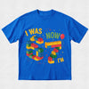 Blue t-shirt with colorful building block design and text on a light gray background