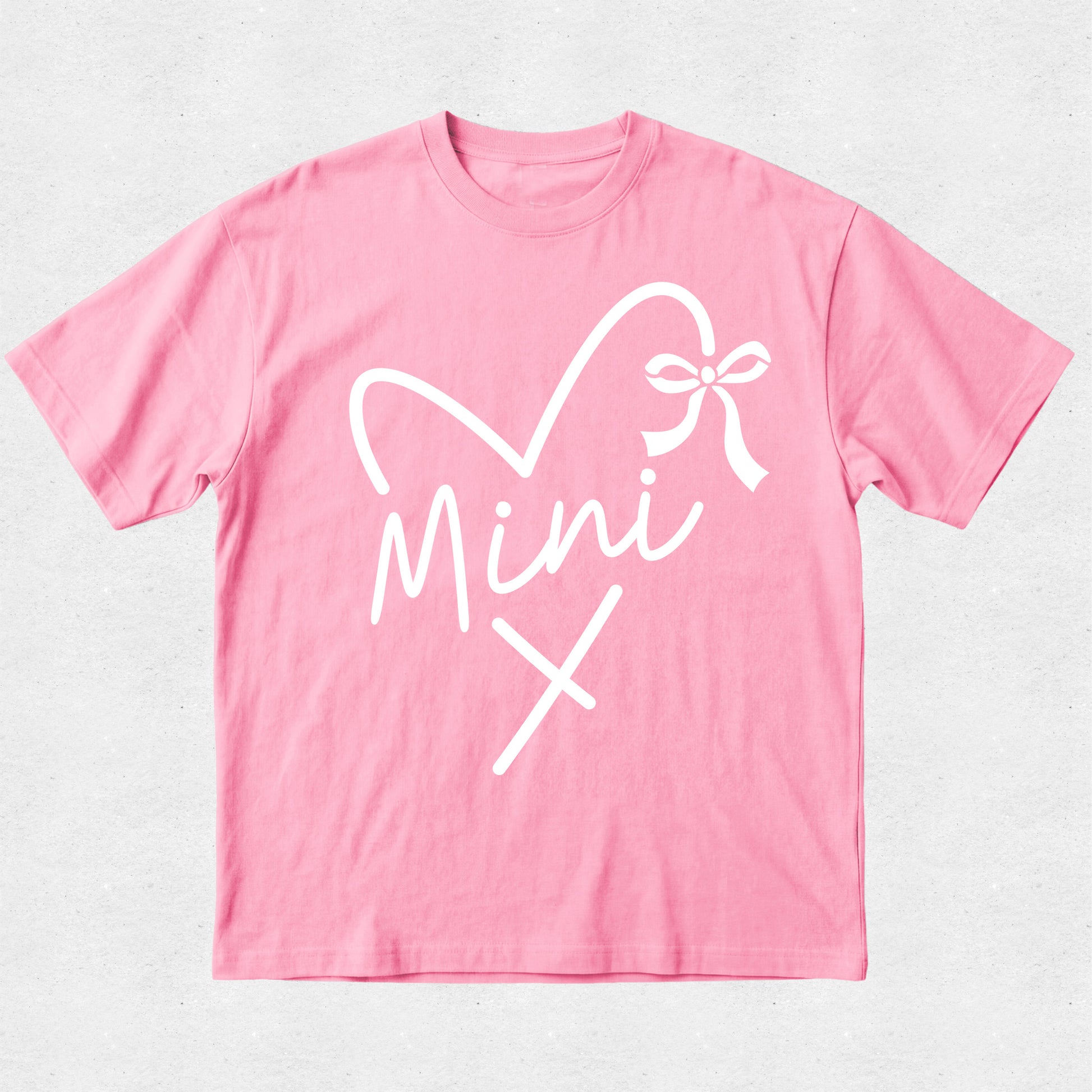 Pink t-shirt with white graphic design on a light gray background