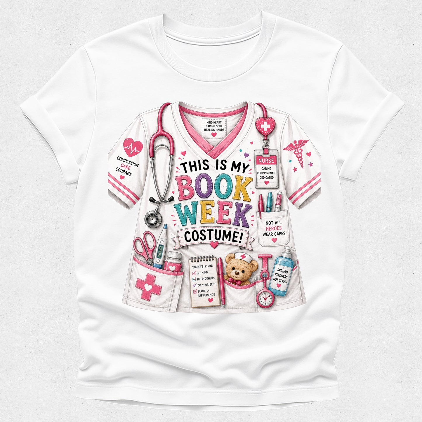 A white short-sleeve crewneck t-shirt featuring a colorful graphic print of a book-themed nurse costume. The graphic includes a pink and white scrub top with a stethoscope, pockets holding a teddy bear and books, and text that reads 'THIS IS MY BOOK WEEK COSTUME!'.