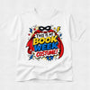 A white short-sleeve crewneck t-shirt featuring a colorful comic book style graphic on the chest that reads 'THIS IS MY BOOK WEEK COSTUME!' with a superhero mask, cape, stars, and comic-style text elements.