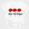 White t-shirt with red poppies and 'Lest We Forget' text on a white background