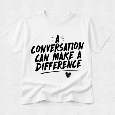 A white short-sleeve crewneck t-shirt with a black graphic text print that reads 'A CONVERSATION CAN MAKE A DIFFERENCE' with a small heart and line details, displayed flat against a light gray textured background.