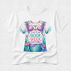 A white short-sleeve crewneck t-shirt featuring a colorful graphic print of a mermaid costume with the text 'THIS IS MY BOOK WEEK COSTUME!' in purple and teal lettering.