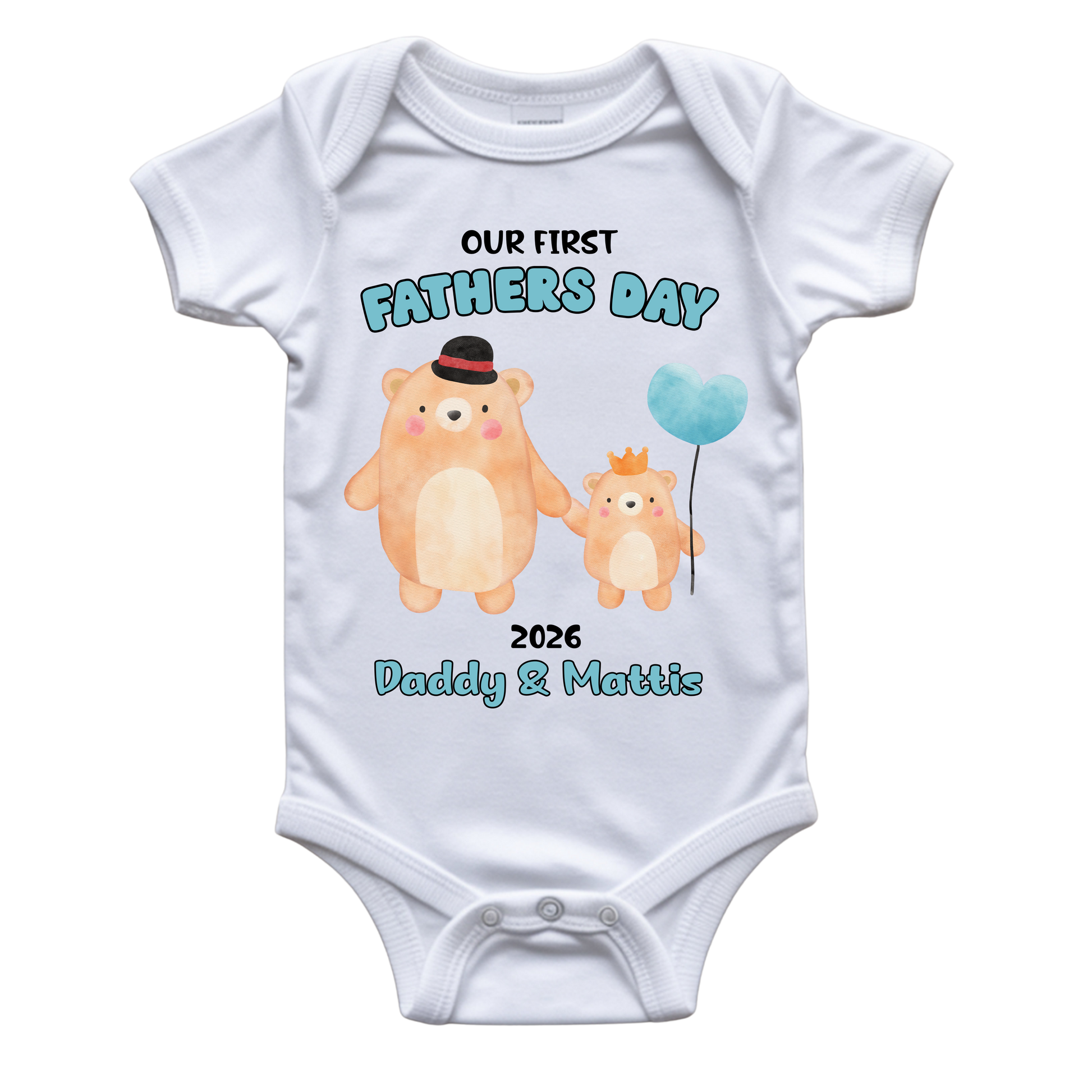 A white short-sleeve baby bodysuit with a custom 'Our First Fathers Day' graphic. The graphic features two watercolor-style teddy bears holding hands, one larger bear wearing a black top hat and one smaller bear wearing a small gold crown, holding a light blue balloon.