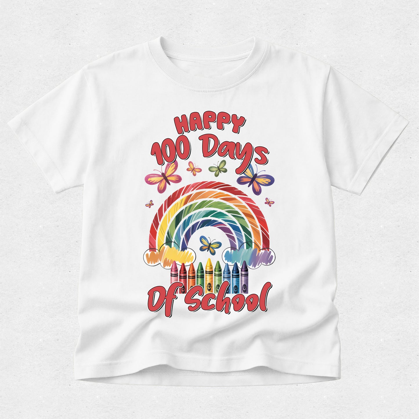 A white short-sleeve t-shirt with a colorful graphic on the front that reads 'Happy 100 Days Of School' above and below a rainbow, butterflies, and crayons, shown on a light gray textured background.