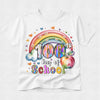 A white short-sleeve T-shirt with a colorful '100th Day of School' graphic on the front, featuring a rainbow, hearts, clouds, and a school apple, shown on a light gray background.