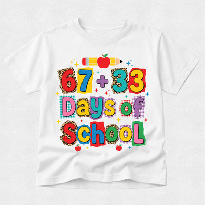 A white short-sleeve t-shirt with a colorful graphic that reads '67 + 33 Days of School' in playful multicolored letters, decorated with a pencil, apple, and leopard-print patterned letters, shown on a light gray background.
