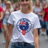 Woman wearing a white t-shirt with a ' lest we forget' design in a crowd.