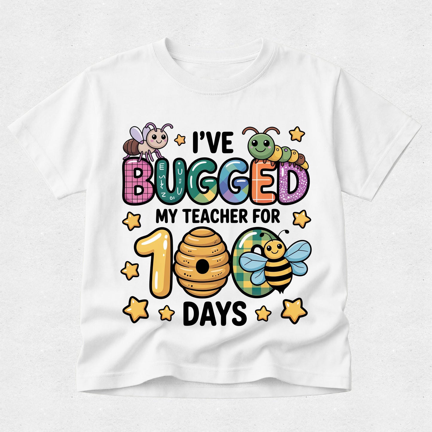 A white short-sleeve crewneck t-shirt featuring a colorful cartoon graphic of bees, a caterpillar, and a beehive with the text 'I'VE BUGGED MY TEACHER FOR 100 DAYS' in playful multicolored lettering, shown on a light gray textured background.