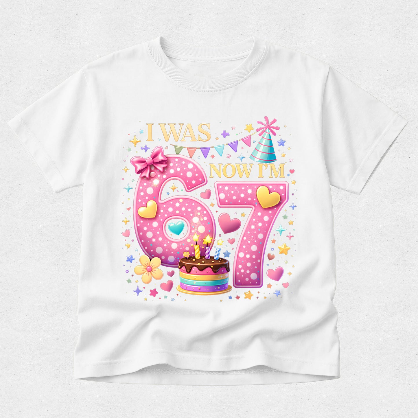 White t-shirt with a birthday-themed design featuring the numbers 6 and 7, colorful decorations, and text on a white background.