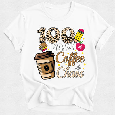 A white short-sleeve crewneck t-shirt featuring a graphic design that reads '100 DAYS of Coffee & Chaos' in leopard print, brown, pink, and gold tones, accompanied by illustrations of a coffee cup, books, and an apple.