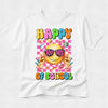 A white short-sleeve crewneck t-shirt featuring a colorful 'Happy 100 Days of School' graphic on the front. The graphic includes a yellow smiley face wearing pink sunglasses, colorful checkered background, and school-themed illustrations like pencils, flowers, and apples.
