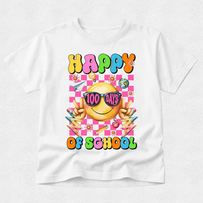 A white short-sleeve crewneck t-shirt featuring a colorful 'Happy 100 Days of School' graphic on the front. The graphic includes a yellow smiley face wearing pink sunglasses, colorful checkered background, and school-themed illustrations like pencils, flowers, and apples.