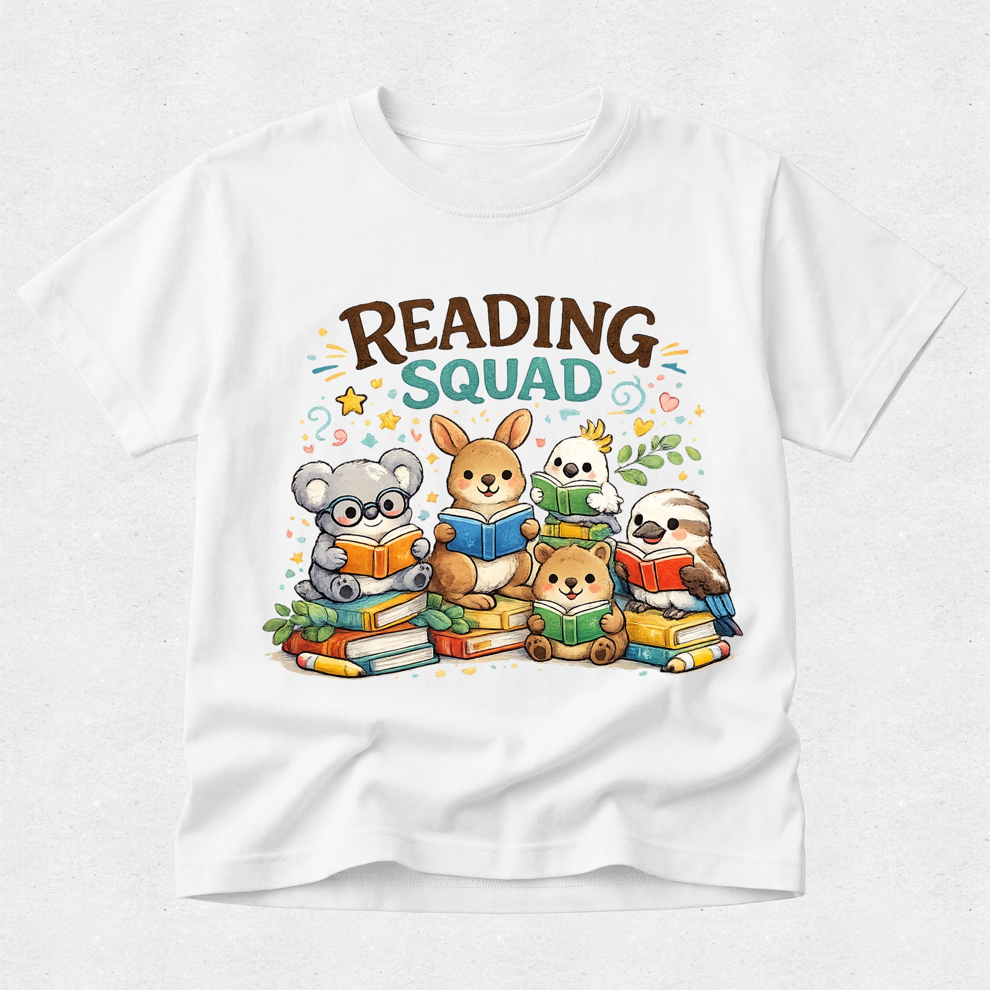 A white short-sleeve crewneck t-shirt featuring a colorful cartoon graphic of five animals reading books, with the text 'READING SQUAD' printed above them.