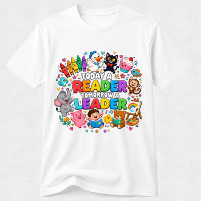A white short-sleeve crewneck t-shirt featuring a colorful cartoon graphic on the front with the text 'TODAY A READER TOMORROW A LEADER' surrounded by playful children, animals, and school-themed illustrations.