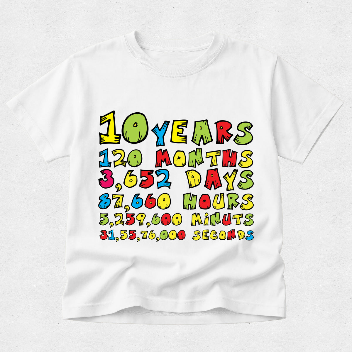 A white short-sleeve t-shirt with a colorful retro-style graphic on the front that lists milestones for 10 years: 120 months, 3,652 days, 87,660 hours, 5,239,600 minutes, 31,537,600 seconds.