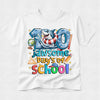 A white short-sleeve crewneck t-shirt featuring a colorful graphic design on the front. The design reads '100 jawsome days of school' with a cartoon shark wearing a red and white life preserver inside the number '100', surrounded by school-themed icons like a globe, compass, ruler, pencil, and starbursts.