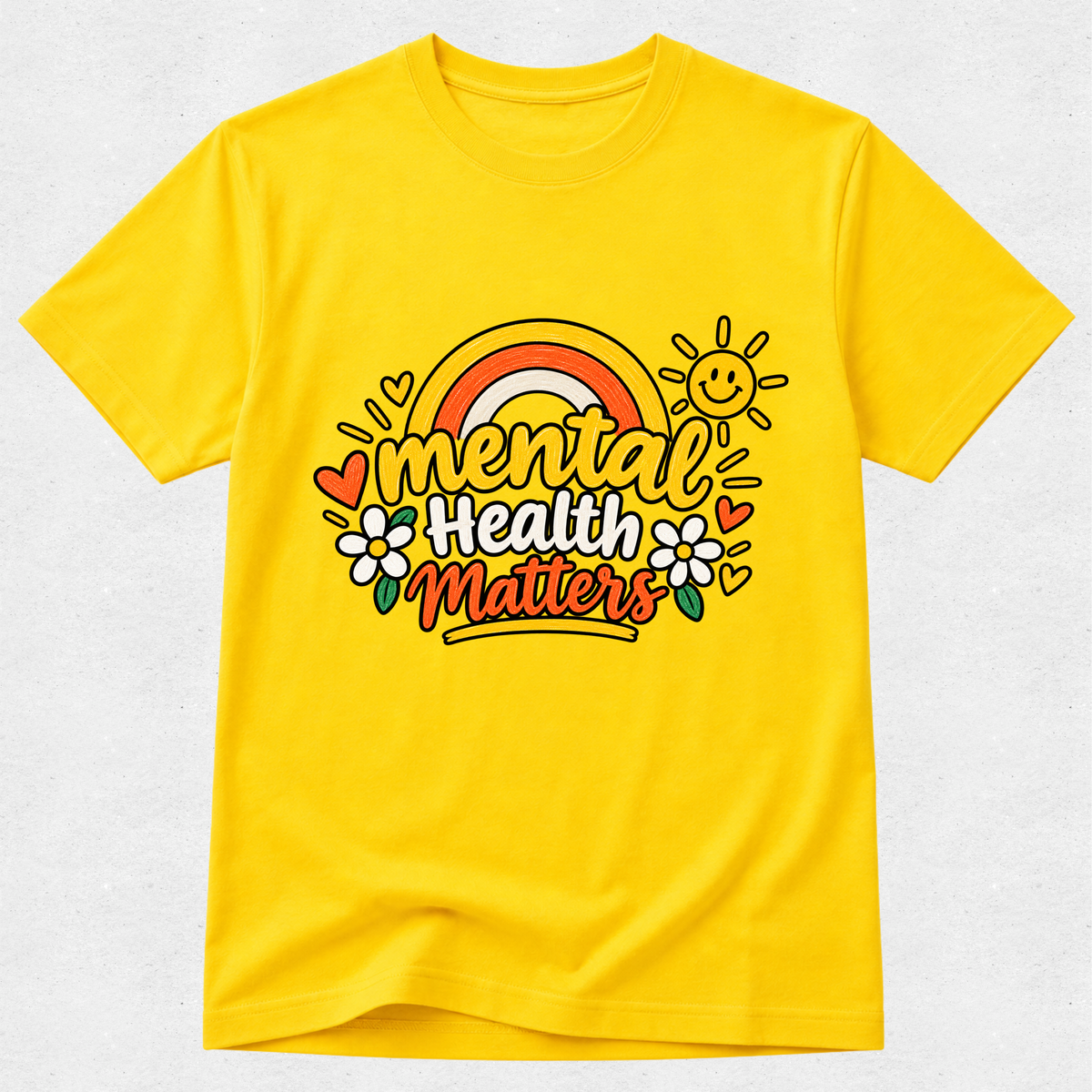 A bright yellow short-sleeve t-shirt with a colorful graphic on the chest that reads 'mental health matters' in a rainbow-themed design, displayed on a light gray textured background.