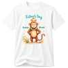 A white short-sleeve crewneck t-shirt featuring a colorful graphic of a cartoon baby monkey sitting on its dad's shoulders. The graphic includes the text 'Father's Day' in teal above and 'Daddy Brady' in teal below, with small beige and green decorative elements at the bottom.