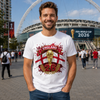 Man wearing a white t-shirt with England 2026 design in front of a stadium with FIFA World Cup 2026 signage.