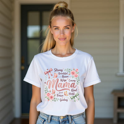Woman wearing a white mama t-shirt with floral text design standing outside a house.