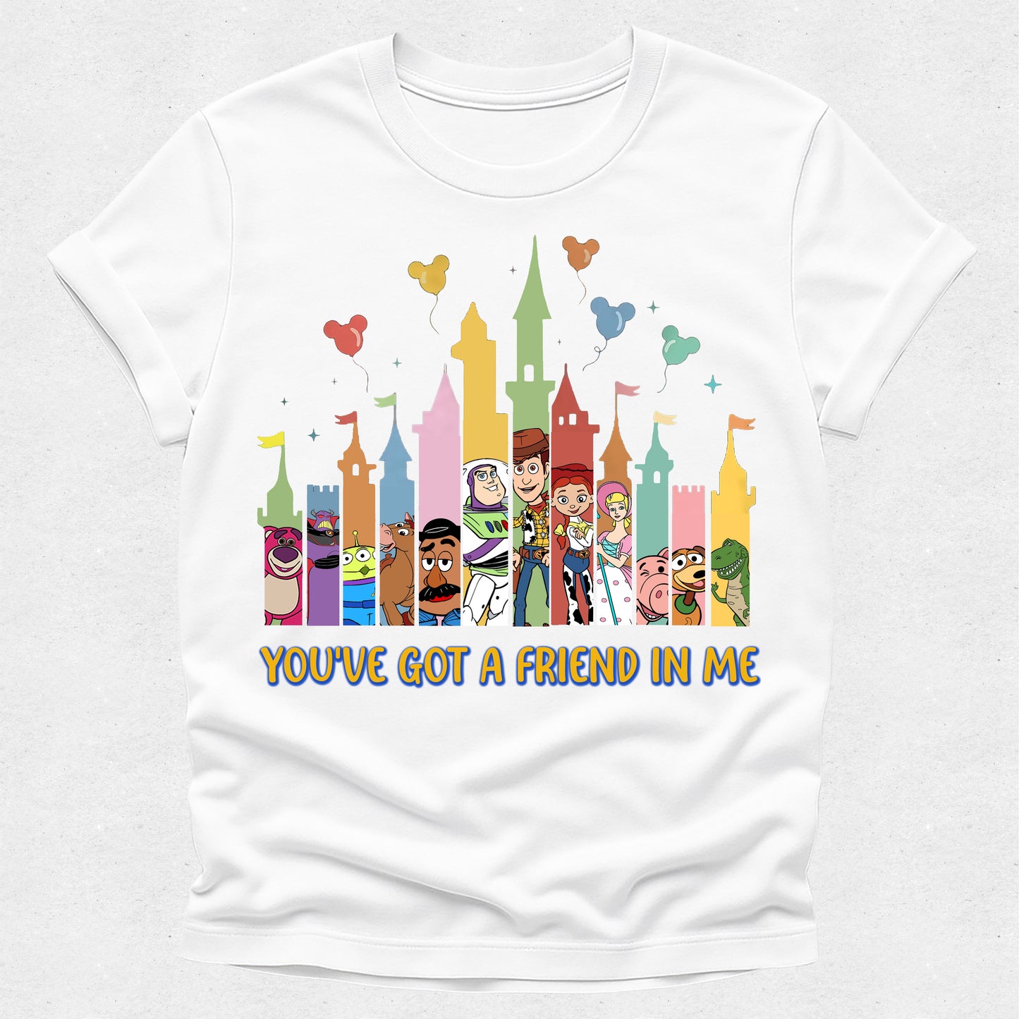 White t-shirt with colorful cartoon characters and castle design on a white background