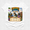 A white short-sleeve crewneck t-shirt featuring a colorful graphic print of an underwater scene with a child explorer, coral reef, sea turtle, and a treasure chest. The graphic includes the text 'BOOK WEEK QUEST UNDER THE SEA' and 'CAN YOU FIND?'.